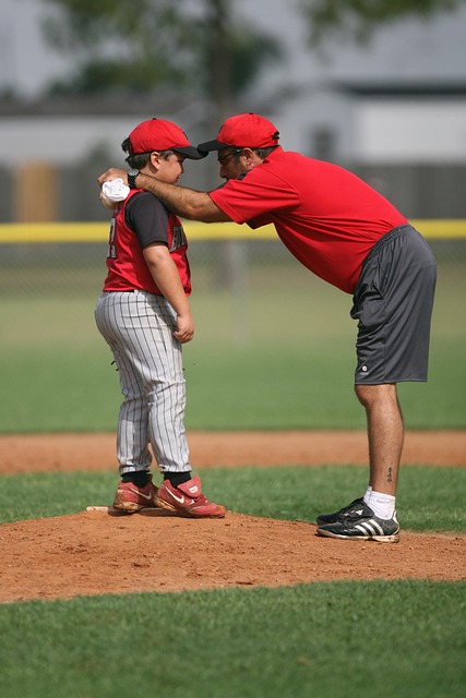 Coach providing tactical guidance on a sports field, strategic planning